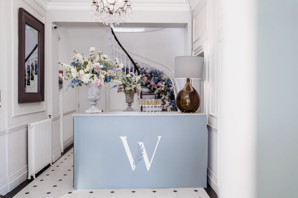 Reception bar with floral arrangements at Woodbourne House wedding and events venue on the Isle of Man