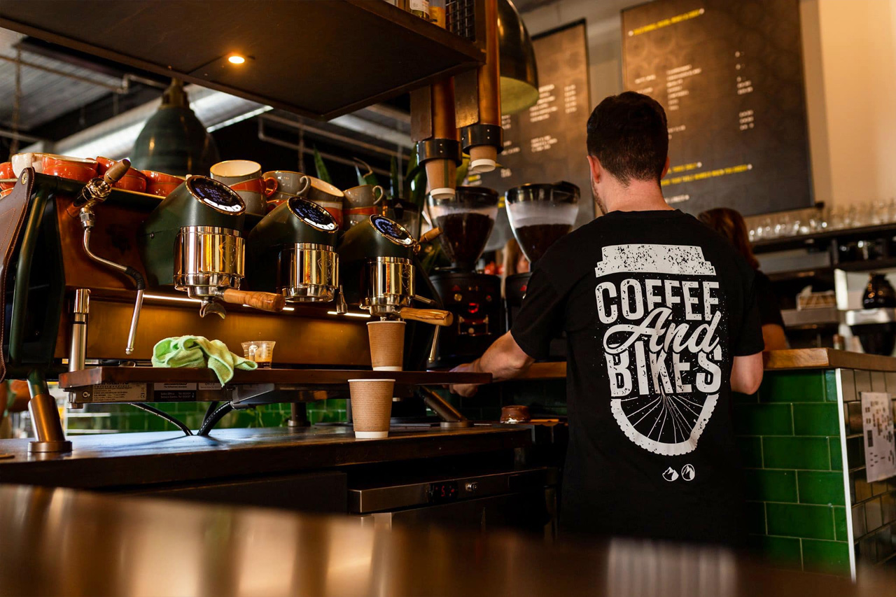 Barista preparing coffee at the espresso machine inside Café 360 on the Isle of Man