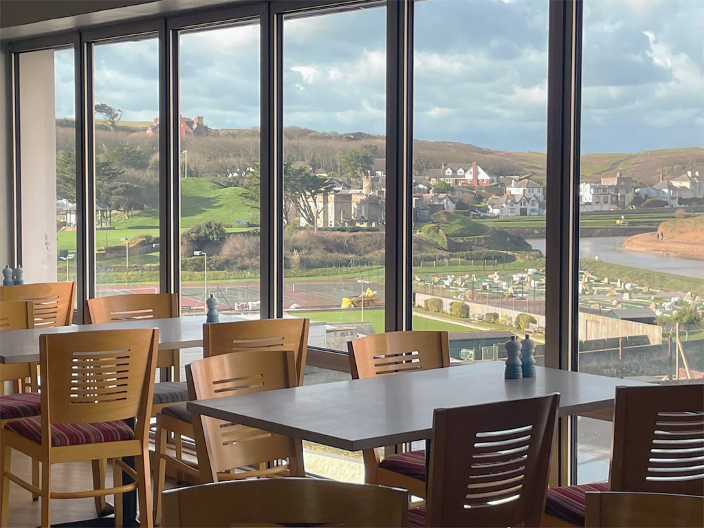 tearoom interior with large windows overlooking cornwall countryside