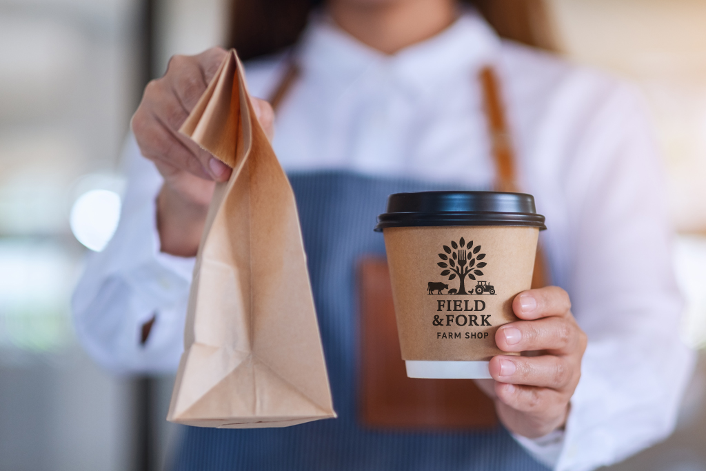 Farm shop customer takeaway coffee and retail purchase in a mixed retail and hospitality environment