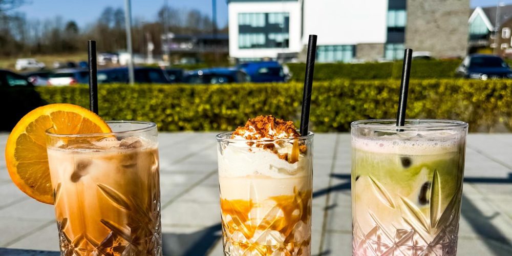 Three iced drinks served outdoors at Café 360 on the Isle of Man on a sunny day