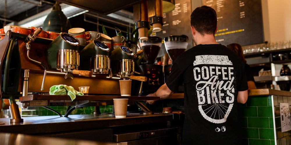 Barista preparing coffee at the espresso machine inside Café 360 on the Isle of Man