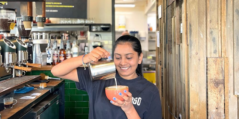 Barista pouring milk to make coffee at Café 360 on the Isle of Man