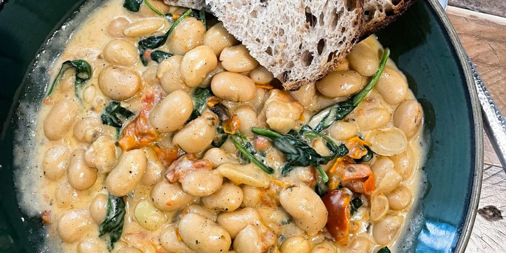 Creamy butter beans with greens served at Café 360 on the Isle of Man with toasted sourdough