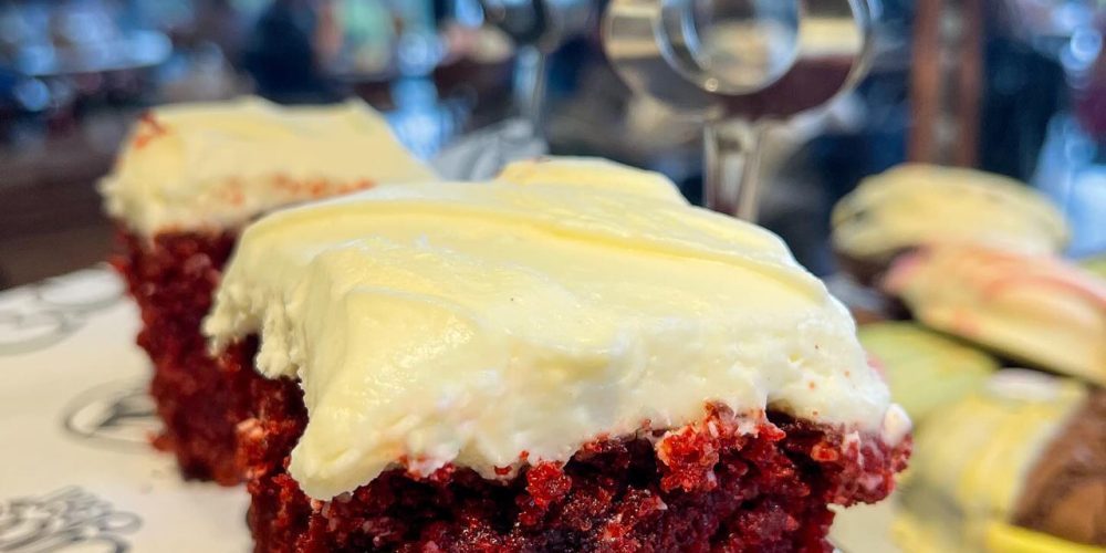 Slice of red velvet cake with cream cheese frosting on display at Café 360 on the Isle of Man