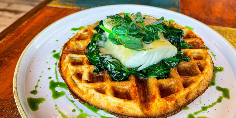 Savoury waffle topped with poached egg and wilted greens at Café 360 on the Isle of Man