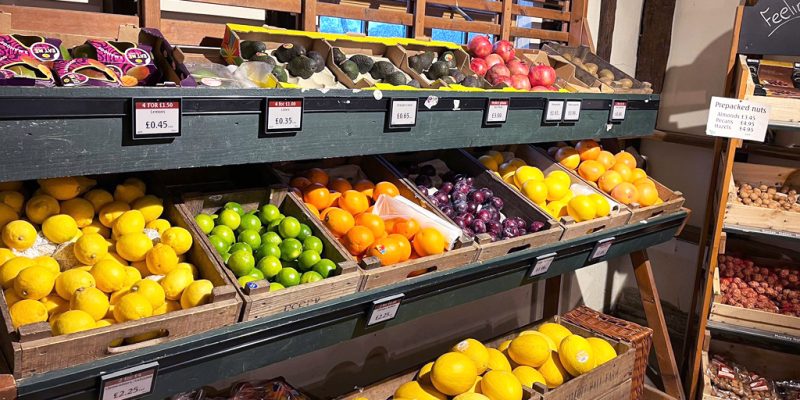 Fresh fruit and vegetable display at Calcott Hall Farm Shop with clear pricing and organised shelving.