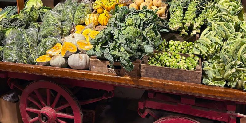 Fresh vegetable display at Calcott Hall Farm Shop with pumpkins, leafy greens, Brussels sprouts and seasonal produce.