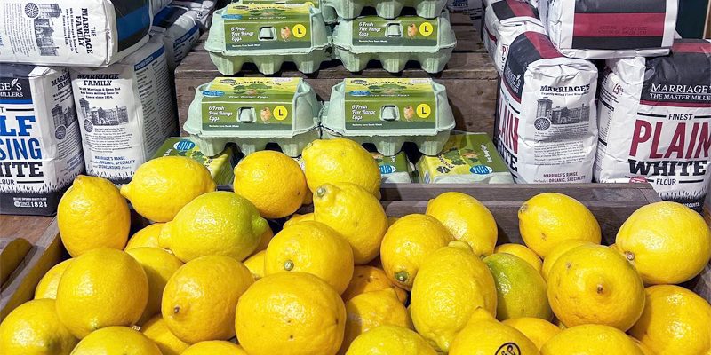 Fresh lemons displayed with free-range eggs and flour at Calcott Hall Farm Shop.