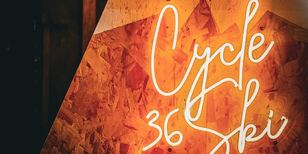 Glowing Cycle 360 neon sign inside Café 360 on the Isle of Man