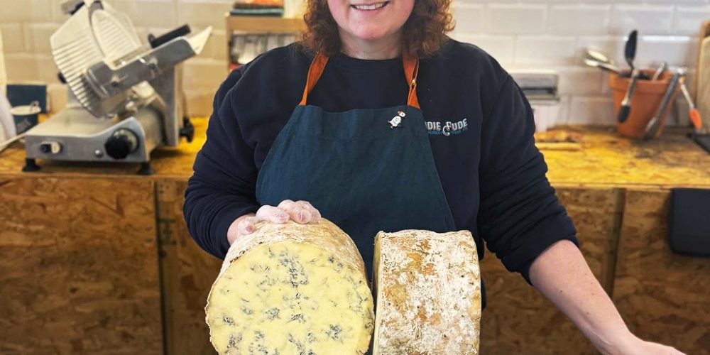 Cheesemonger presenting artisan Irish cheese at Indie Füde cheese counter in Belfast.