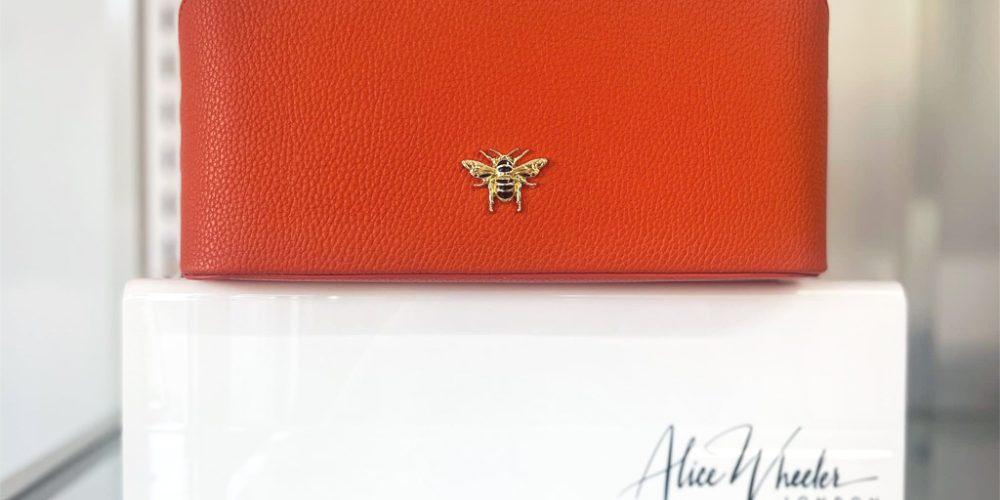 Orange leather accessory case by Alice Wheeler on display at Wroes department store.