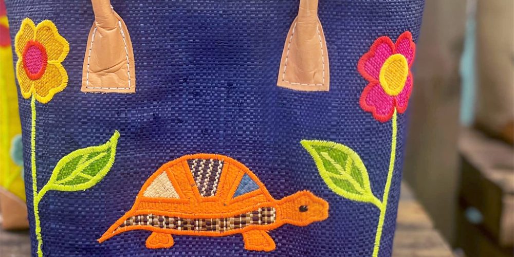 navy tote bag with embroidered turtle and floral design