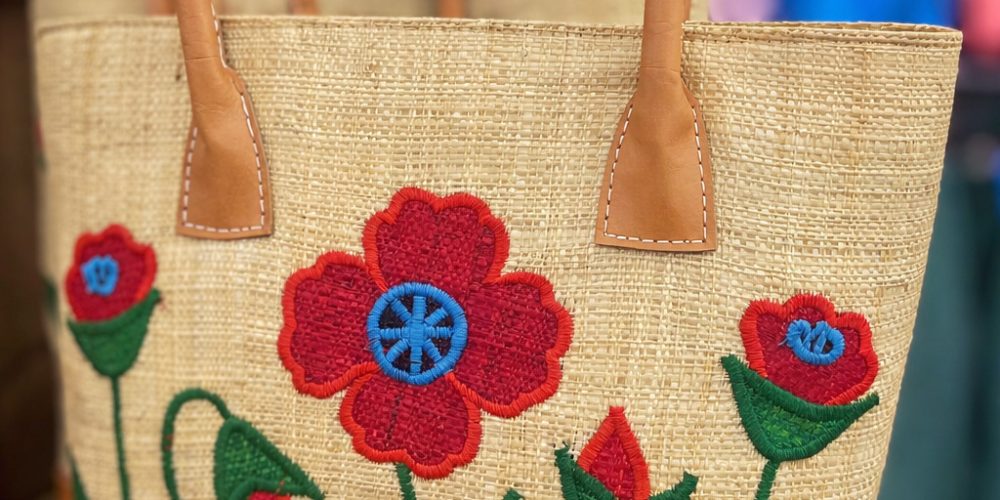 straw tote bag with red flower embroidery and leather handles