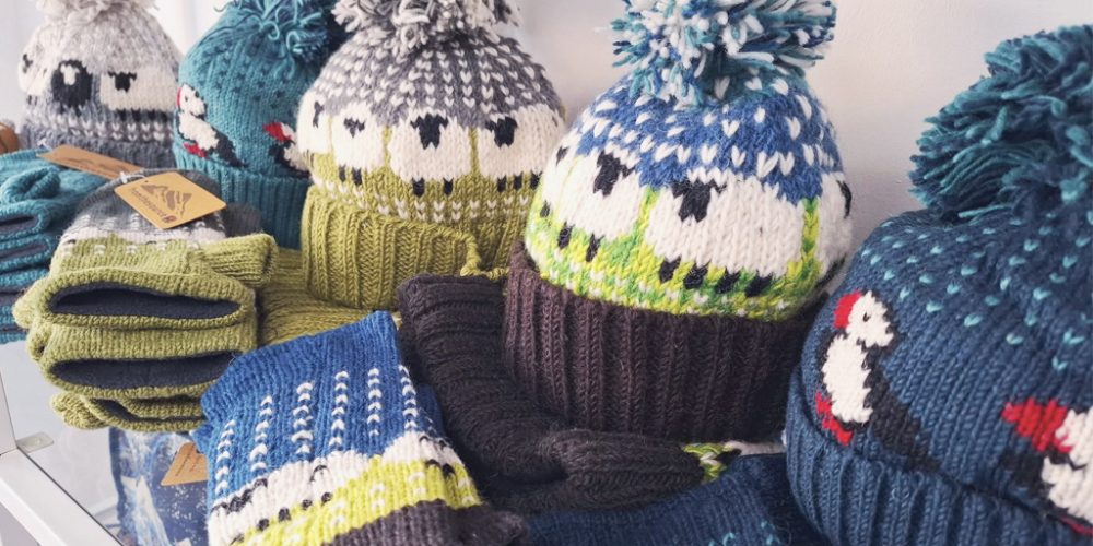 knitted winter hats with pom poms and sheep patterns