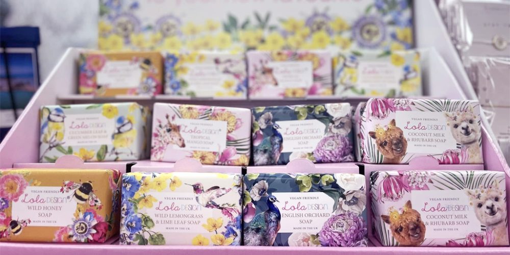 lola design soaps with colourful floral packaging on display
