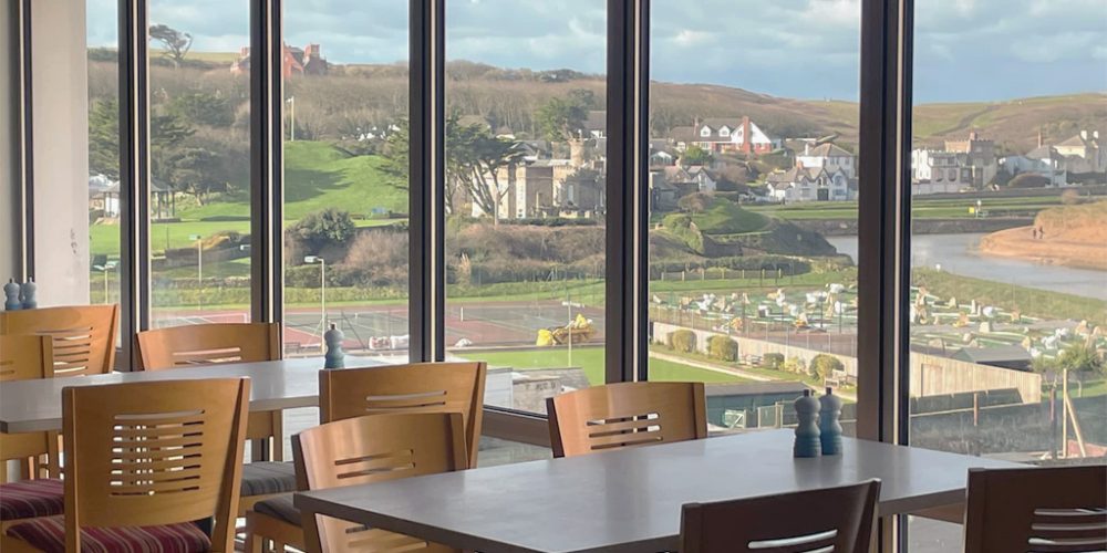 tearoom interior with large windows overlooking cornwall countryside