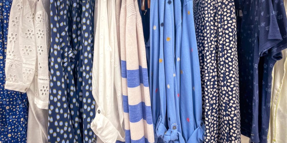 womens clothing rail featuring blue and patterned garments